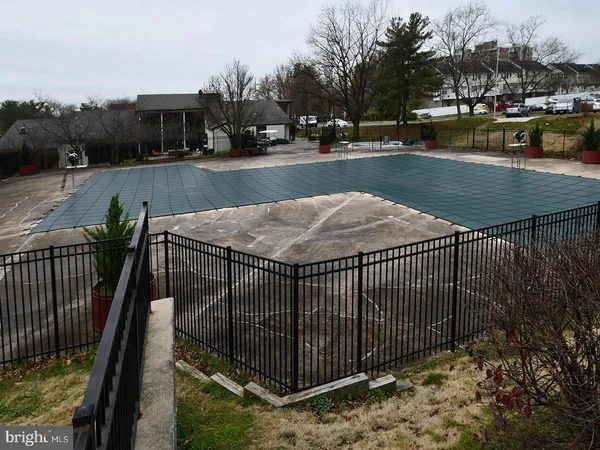 a view of a swimming pool with a patio and a yard