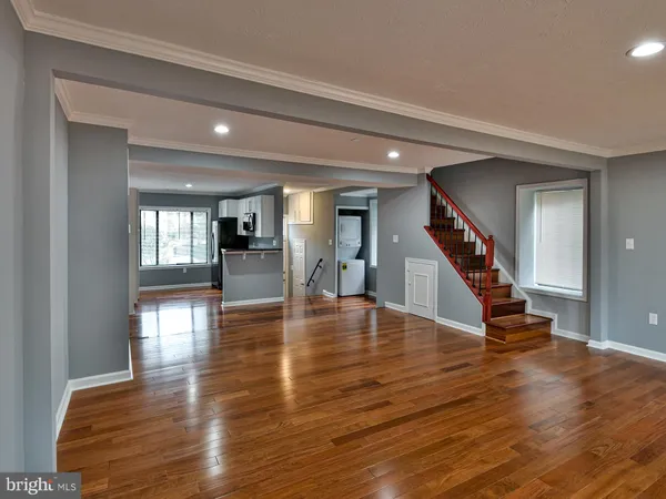 a room with lots of furniture and wooden floor