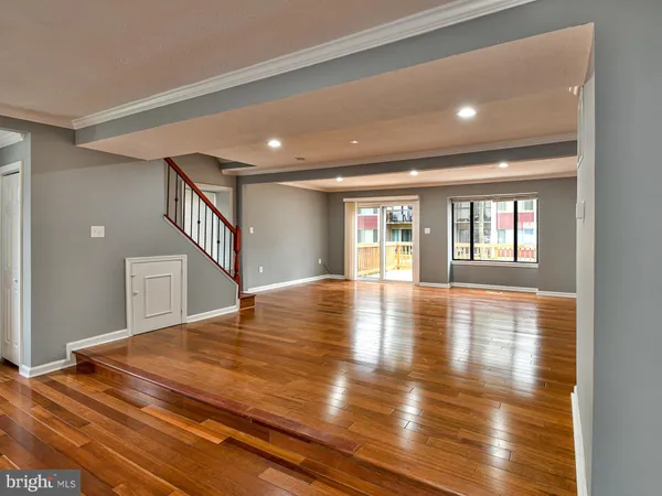 a view of empty room with wooden floor