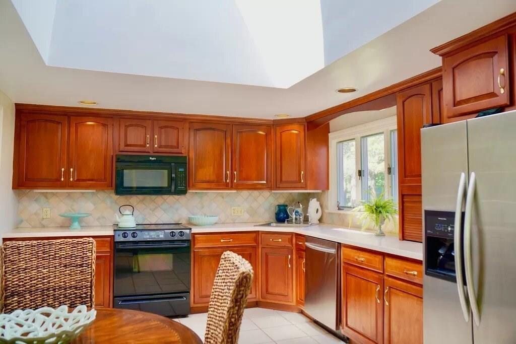 603 Hatherly Road Scituate, MA 02066 - Photo 3 of 19 a kitchen with granite countertop a refrigerator and a stove top oven