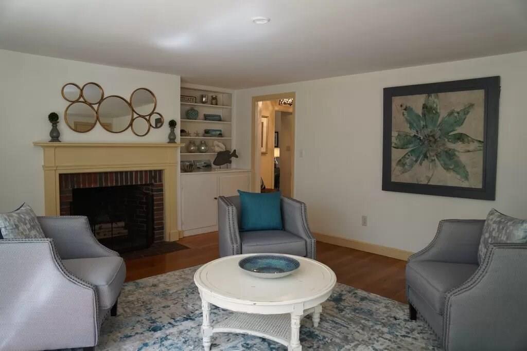 603 Hatherly Road Scituate, MA 02066 - Photo 9 of 19 a living room with furniture and a fireplace