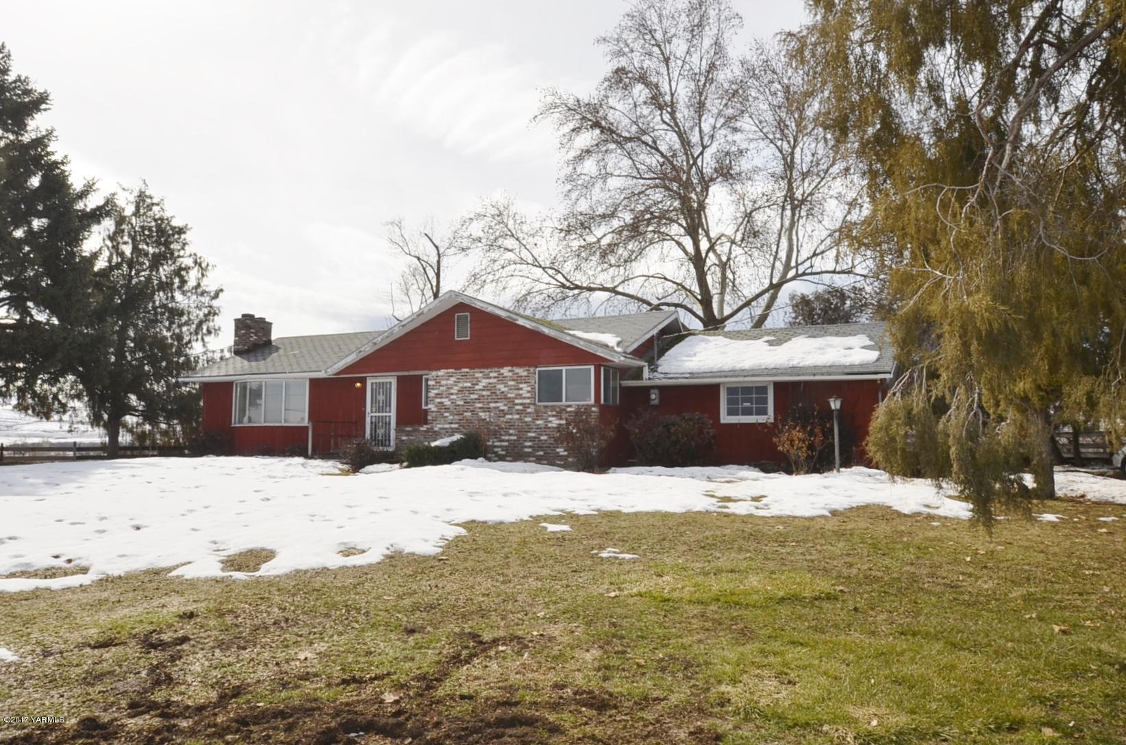 a front view of a house with a yard covered in snow