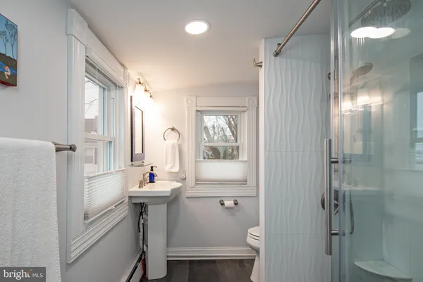 a bathroom with a sink toilet and shower