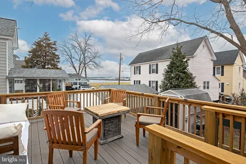 a view of a chair and table on the deck
