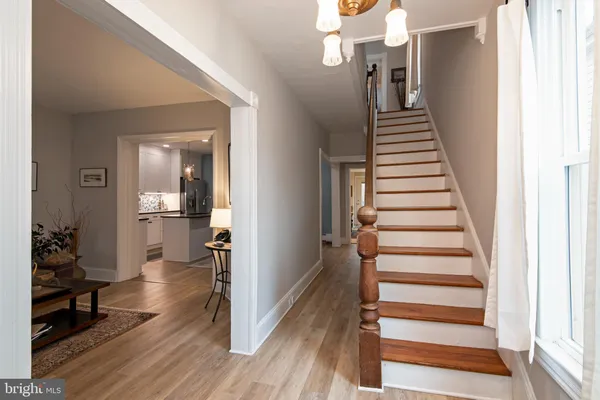 a view of a hallway with wooden floor and entryway