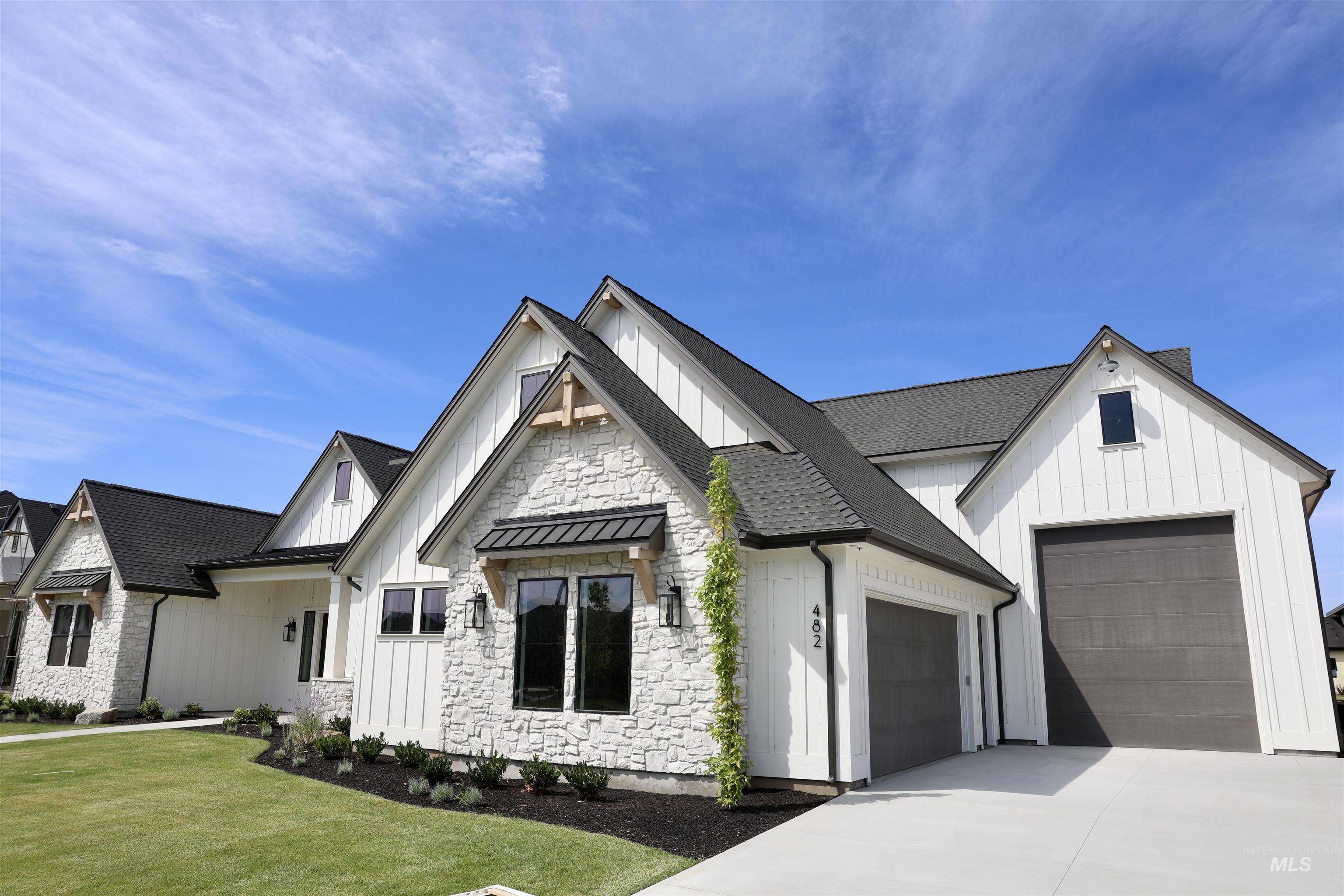 482 Century Avenue Middleton, ID 83644 - Photo 41 of 41 Modern farmhouse with board and batten siding, roof with shingles, driveway, and stone siding