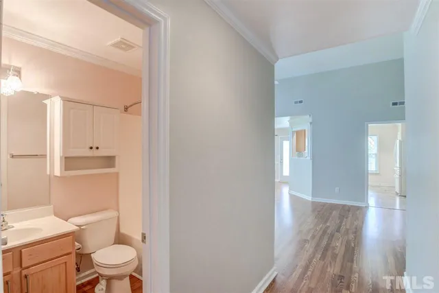 a bathroom with a granite countertop toilet a sink and a mirror
