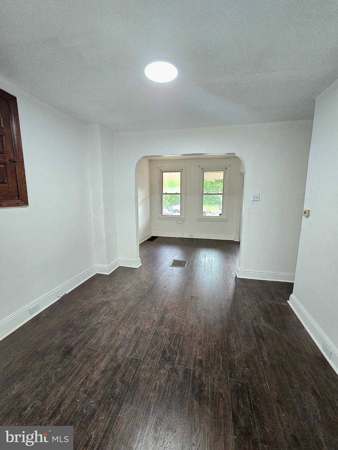 569 Smith Street York, PA 17404 - Photo 8 of 16 a empty room with wooden floor and windows