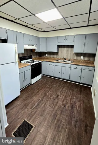 a kitchen with granite countertop a sink and cabinets
