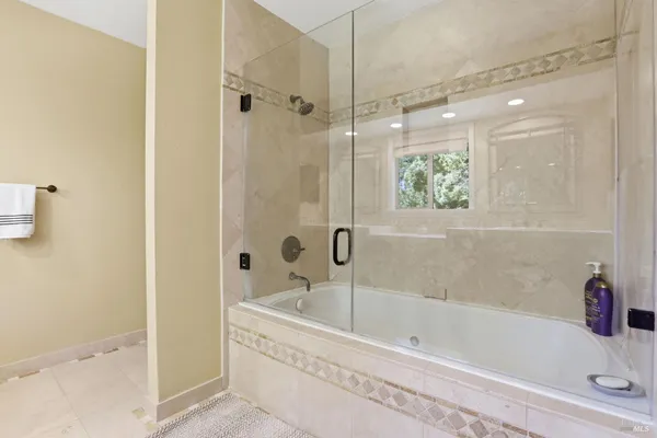 a bathroom with a bathtub and shower