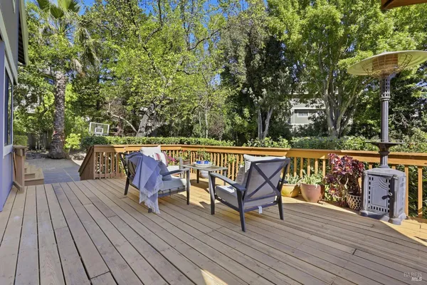 a view of deck with dinning table and chair under an umbrella with wooden floor