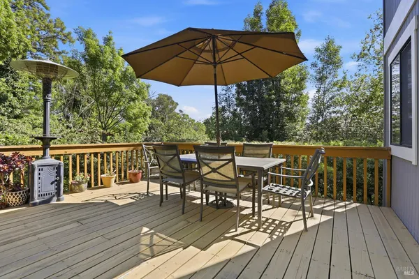 a view of a roof deck with wooden floor and outdoor seating