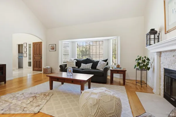 a living room with furniture a fireplace and a table