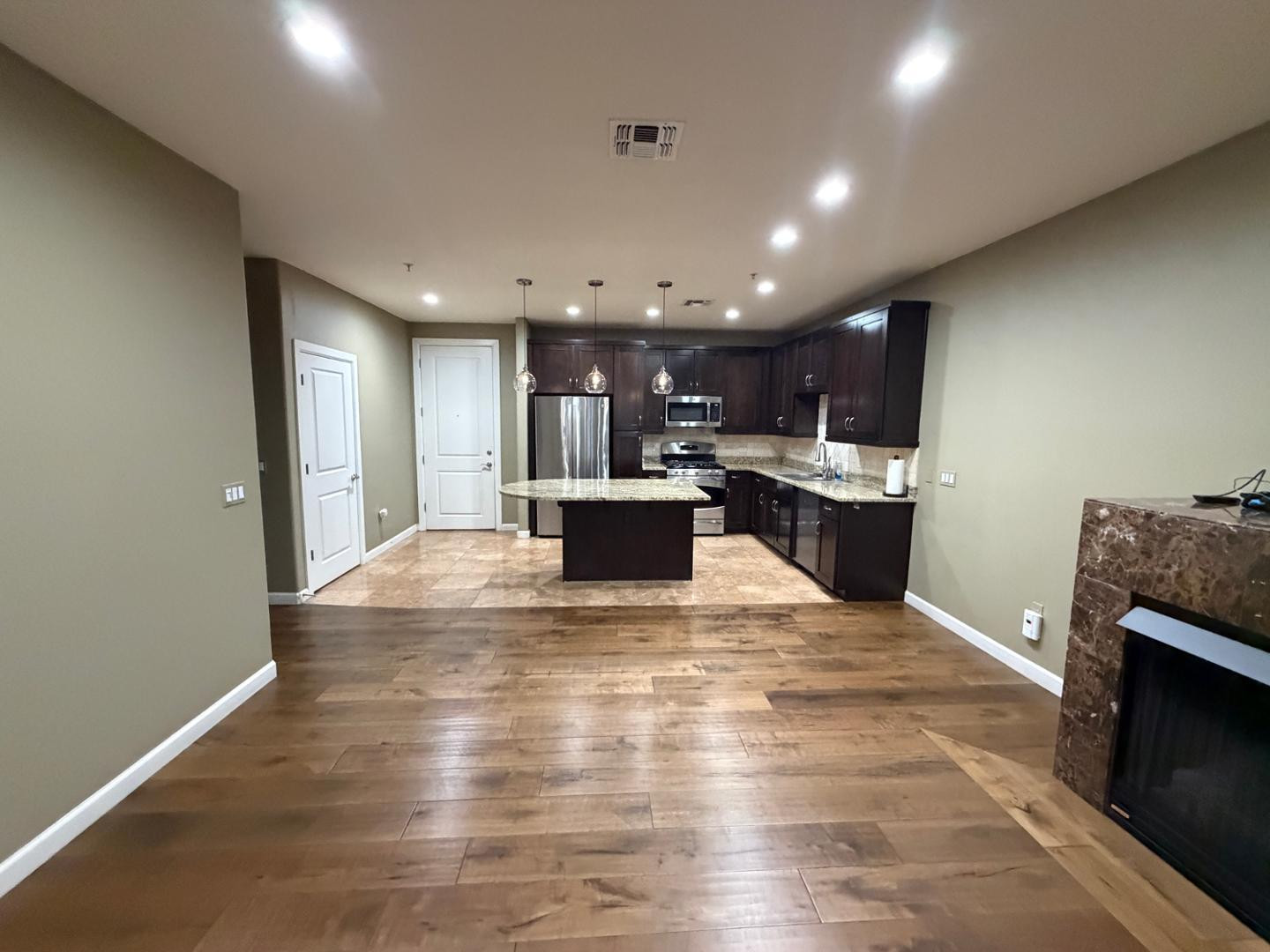 7291 North Scottsdale Road, Unit 1001 Paradise Valley, AZ 85253 - Photo 28 of 34 a view of kitchen with kitchen island wooden floor center island and stainless steel appliances