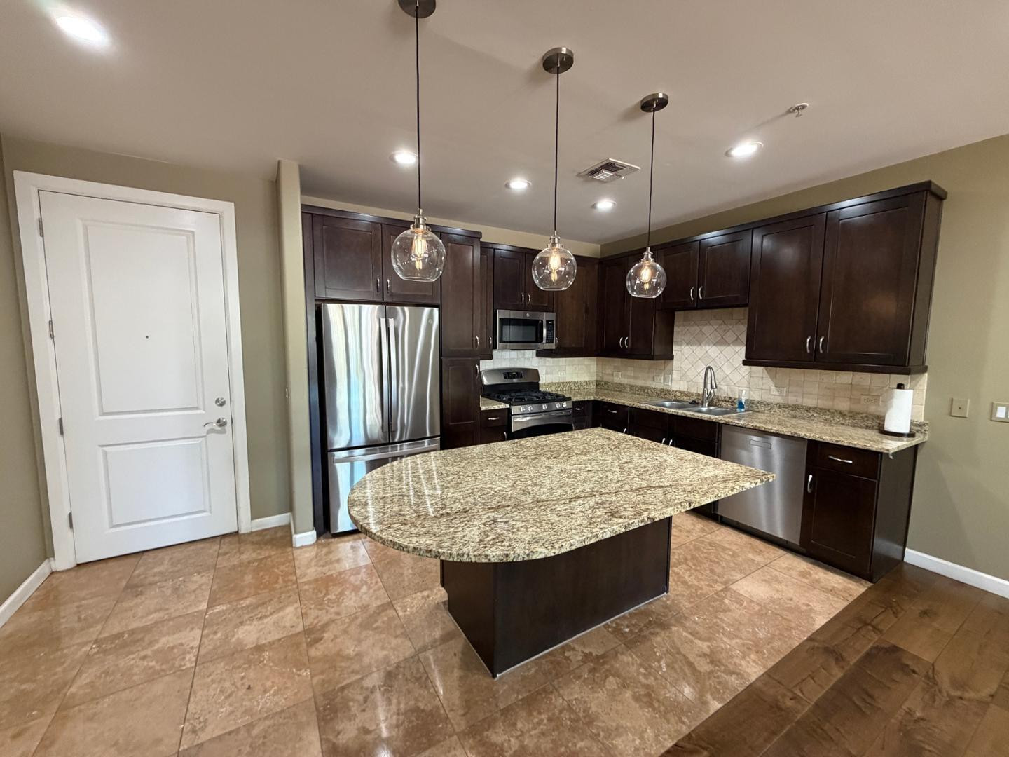7291 North Scottsdale Road, Unit 1001 Paradise Valley, AZ 85253 - Photo 3 of 34 a large kitchen with kitchen island a large center island a stove and refrigerator