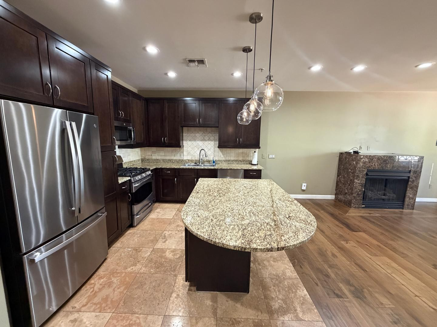 7291 North Scottsdale Road, Unit 1001 Paradise Valley, AZ 85253 - Photo 10 of 34 a kitchen with stainless steel appliances granite countertop a refrigerator and a sink