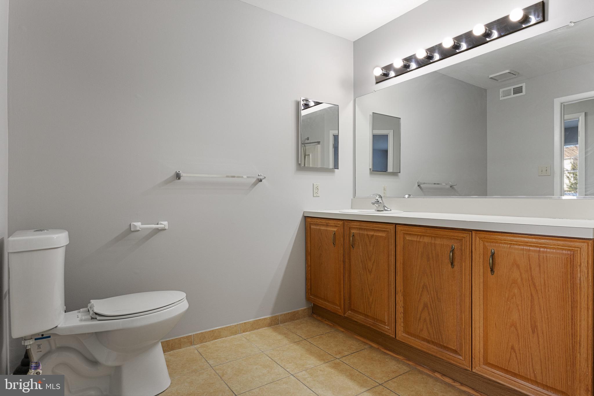 5306 A Aberdeen Drive Mount Laurel, NJ 08054 - Photo 14 of 18 a bathroom with a sink a toilet and mirror