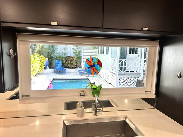 a view of a patio with table and chairs potted plants