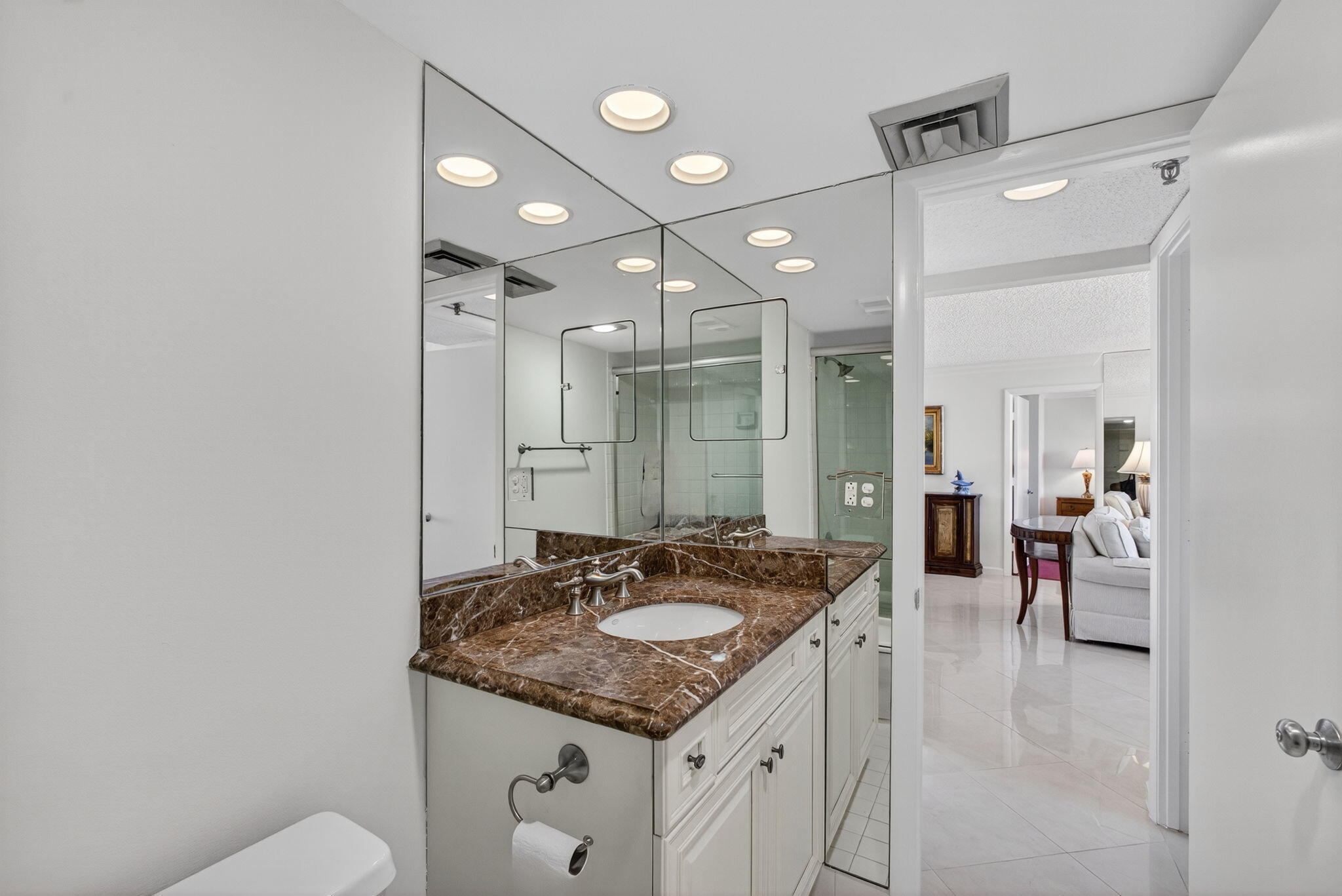 100 Ocean Trail Way, Unit 305 Jupiter, FL 33477 - Photo 11 of 53 a bathroom with a granite countertop sink a mirror and a shower