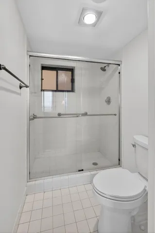 a bathroom with a toilet a sink and shower