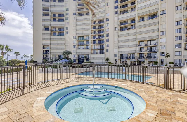 a building outdoor space with swimming pool in front of it