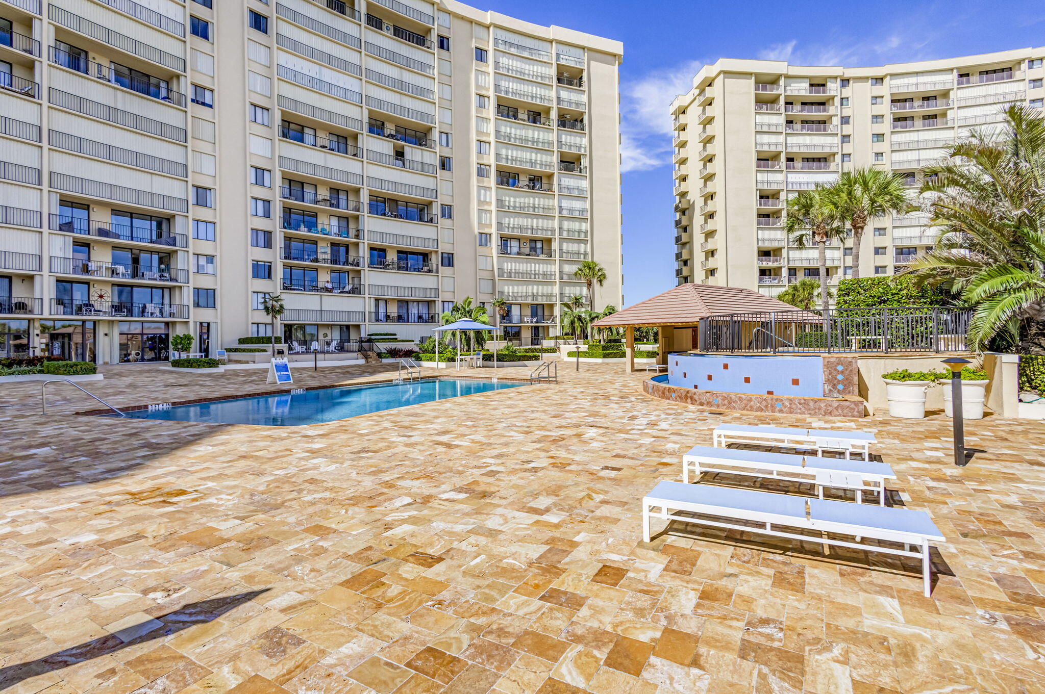100 Ocean Trail Way, Unit 305 Jupiter, FL 33477 - Photo 44 of 53 a building outdoor space with swimming pool in front of it