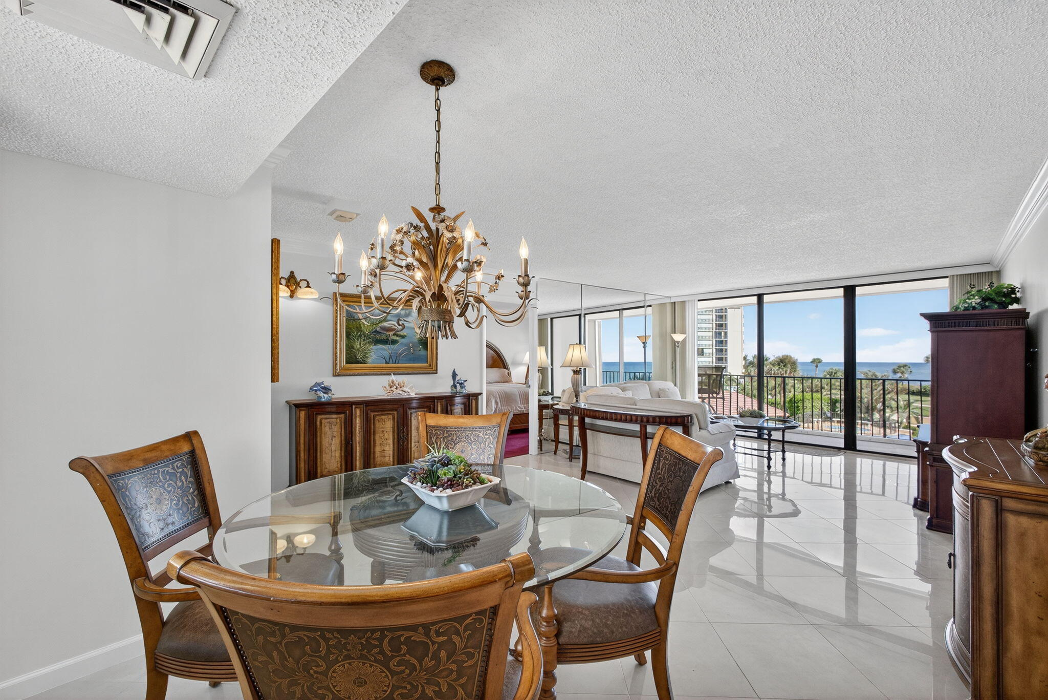 100 Ocean Trail Way, Unit 305 Jupiter, FL 33477 - Photo 6 of 53 a dining room with furniture a chandelier and wooden floor