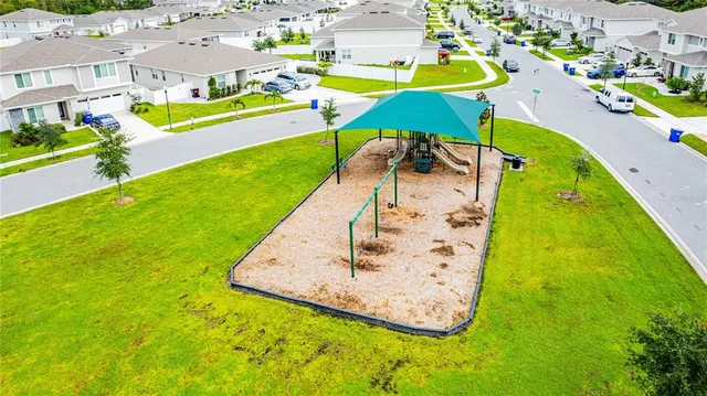 a view of a swimming pool with lawn chairs under an umbrella