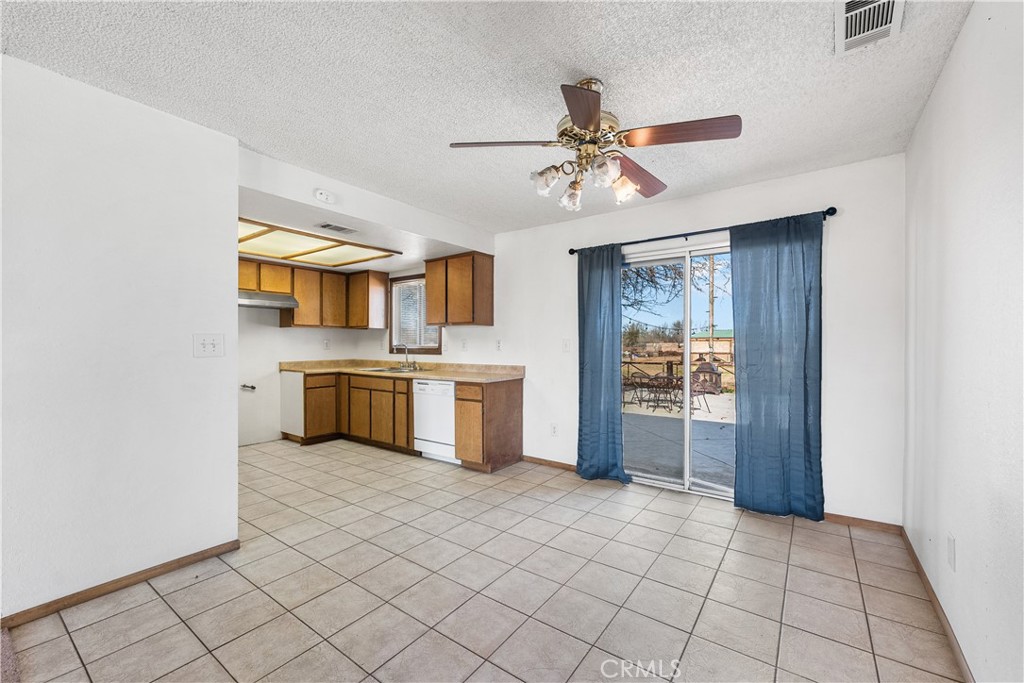 10837 East Ave R 10 Littlerock, CA 93543 - Photo 12 of 50 a kitchen with a cabinets and appliances