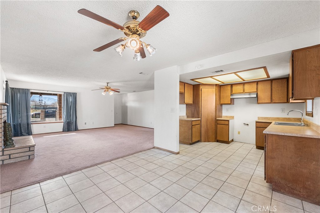 10837 East Ave R 10 Littlerock, CA 93543 - Photo 13 of 50 a view of a kitchen with a sink and a refrigerator