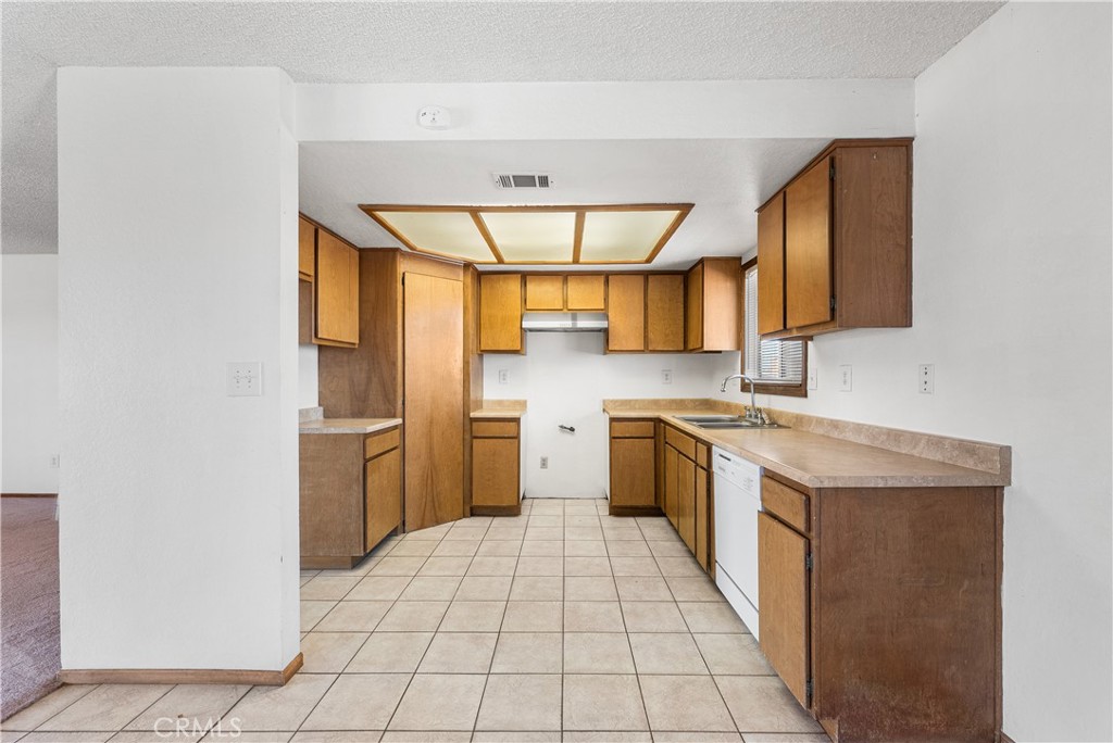 10837 East Ave R 10 Littlerock, CA 93543 - Photo 15 of 50 a kitchen with a sink cabinets and a window