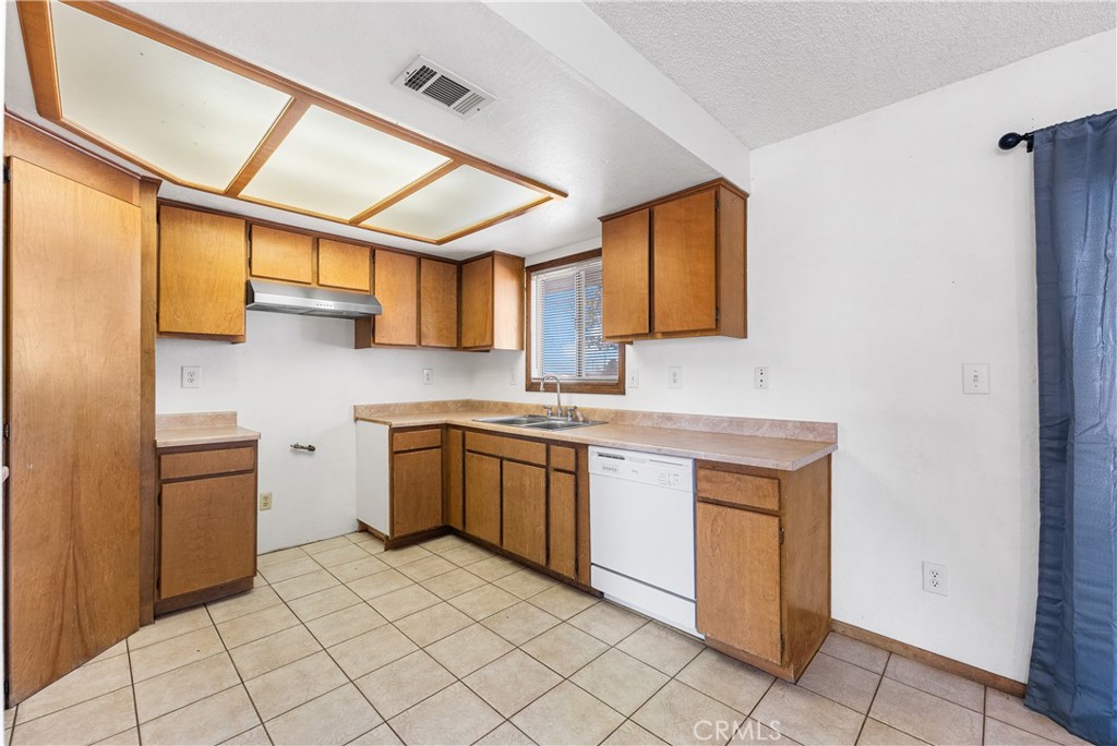 10837 East Ave R 10 Littlerock, CA 93543 - Photo 16 of 50 a kitchen with stainless steel appliances granite countertop a sink and cabinets