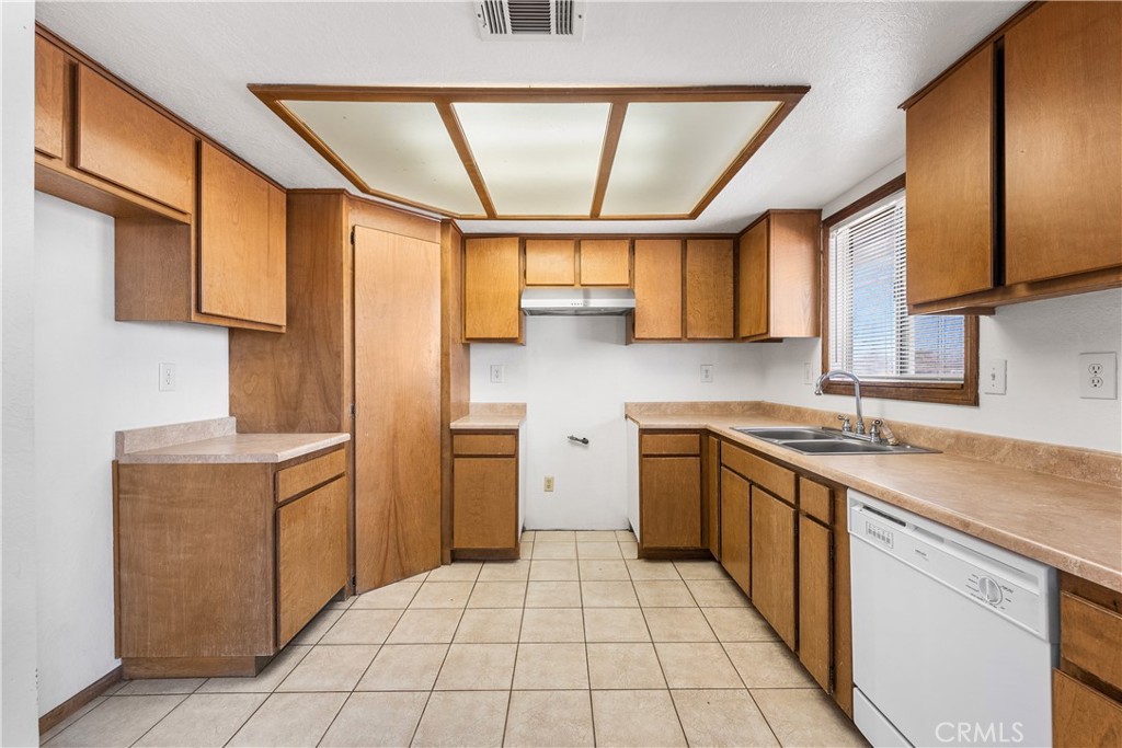 10837 East Ave R 10 Littlerock, CA 93543 - Photo 17 of 50 a kitchen with a cabinets and window