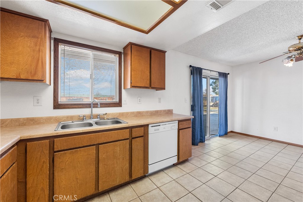 10837 East Ave R 10 Littlerock, CA 93543 - Photo 21 of 50 a kitchen with a sink cabinets and window