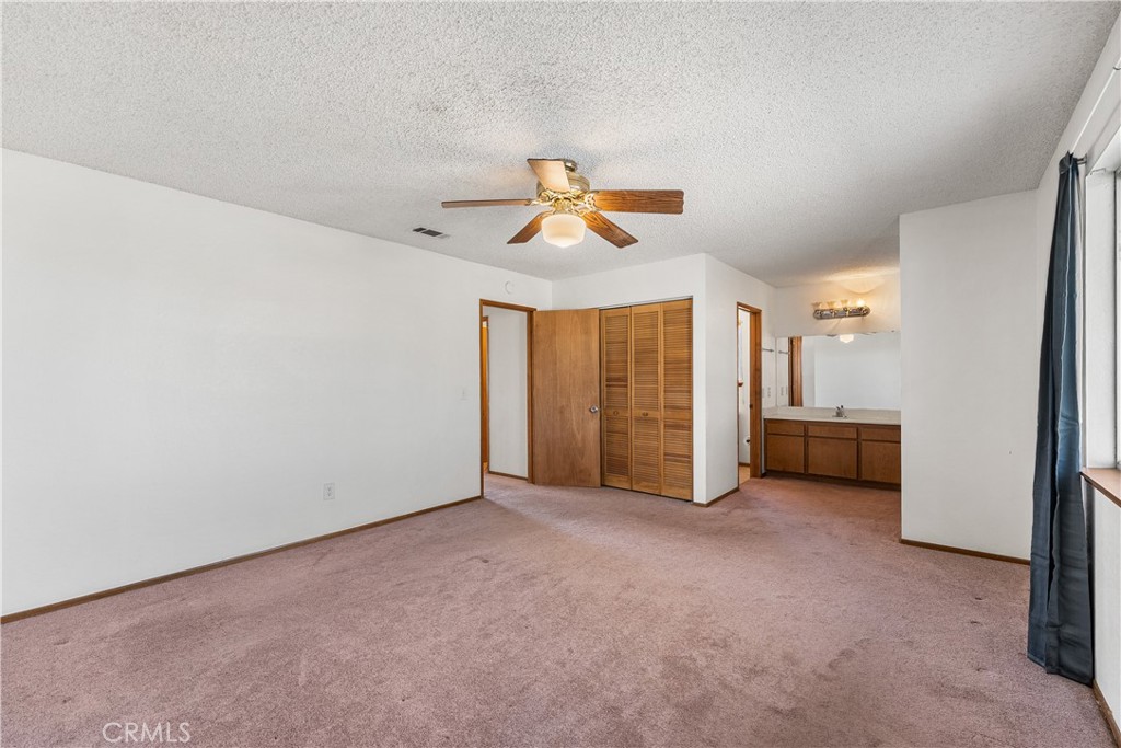 10837 East Ave R 10 Littlerock, CA 93543 - Photo 23 of 50 a view of a livingroom with a ceiling fan and window