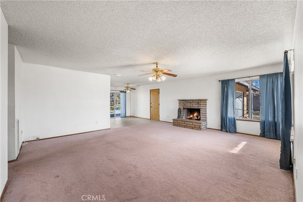10837 East Ave R 10 Littlerock, CA 93543 - Photo 5 of 50 a view of a livingroom with an empty space and a fireplace
