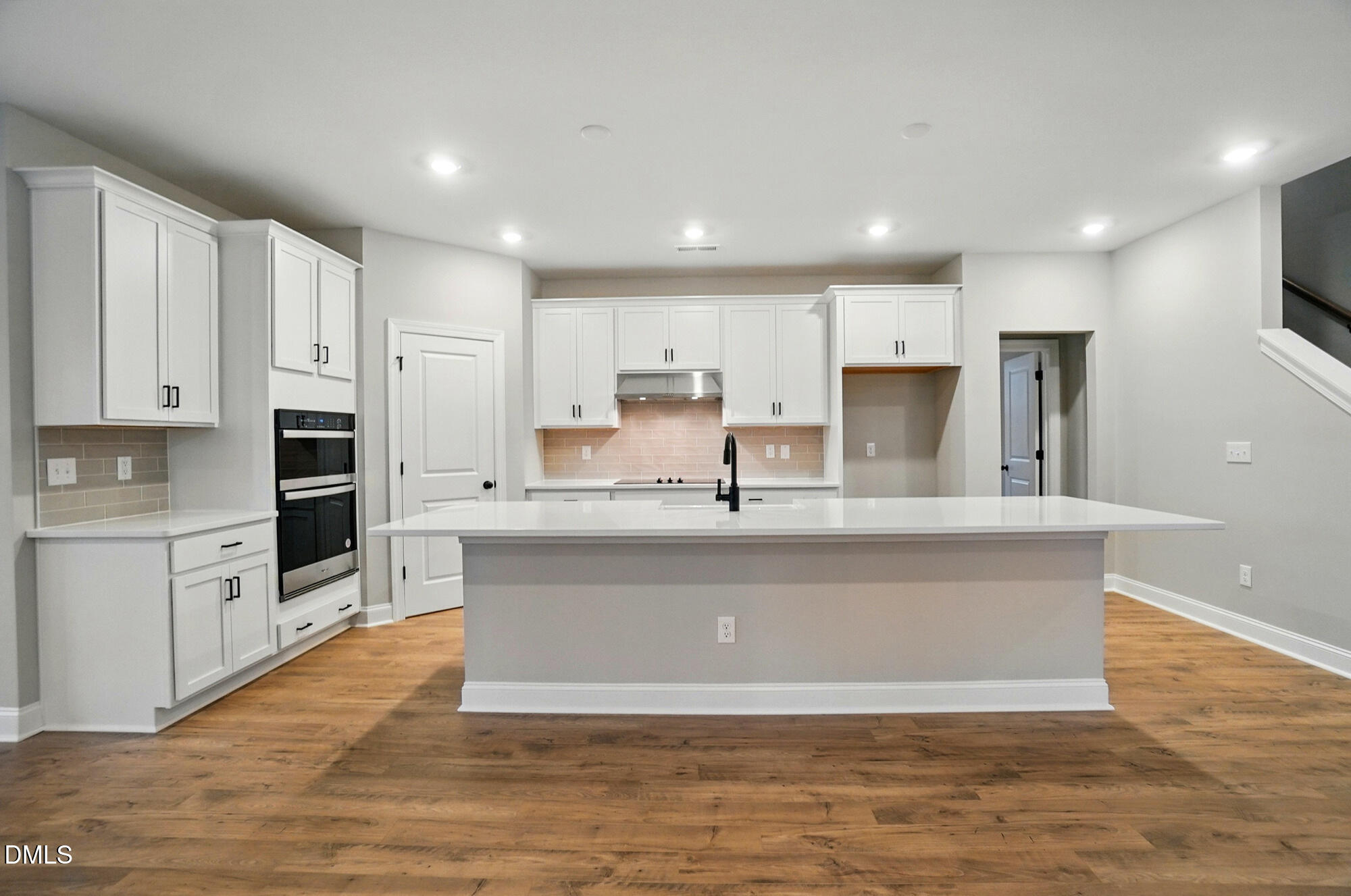 285 Gilliland Road Siler City, NC 27344 - Photo 11 of 45 a view of kitchen with stainless steel appliances granite countertop a stove a sink a refrigerator and white cabinets with wooden floor