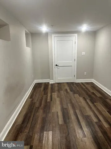 a view of a room with wooden floor