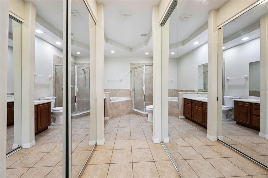 551 Terrace Spring Drive Orlando, FL 32828 - Photo 13 of 41 a bathroom with a glass door shower a sink and a mirror