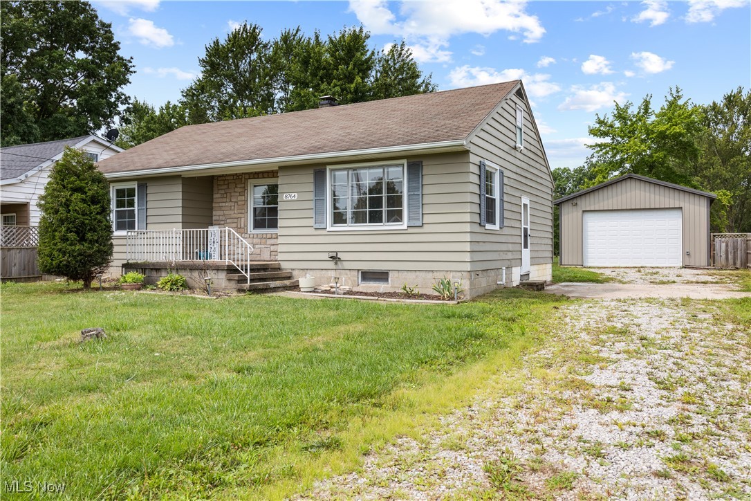 8764 Oberlin Road Elyria, OH 44035 - Photo 1 of 18 View of front facade with a garage, a front lawn, and an outbuilding