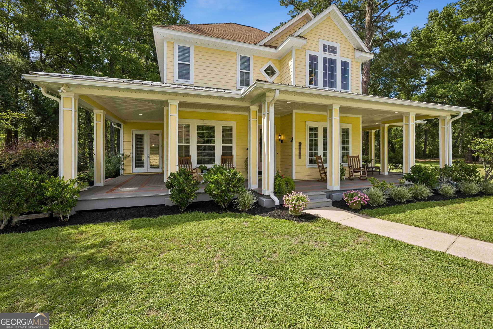 706 Hopewell Point Road White Oak, GA 31568 - Photo 55 of 84 Classic Southern architecture meets modern comfort with a wraparound porch that extends the living space outdoors.