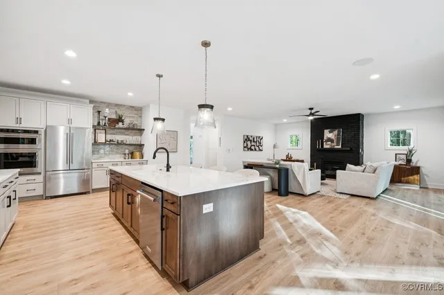 a large kitchen with stainless steel appliances kitchen island granite countertop a large counter top and sink