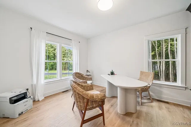 a dining room with furniture and wooden floor
