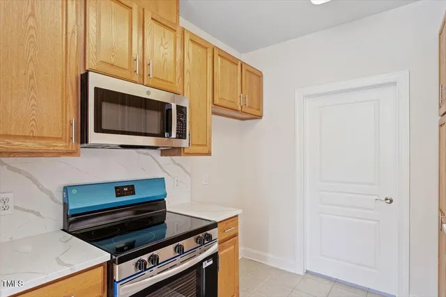 a kitchen with microwave stove and cabinets