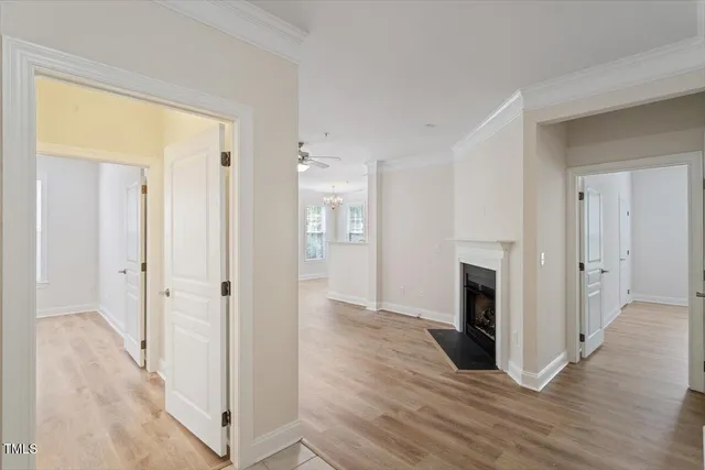 a view of a livingroom with wooden floor and a fireplace