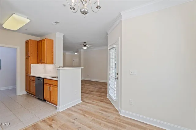 a view of a kitchen with stainless steel appliances a wooden floor