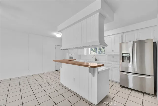 a kitchen with stainless steel appliances a sink and a refrigerator