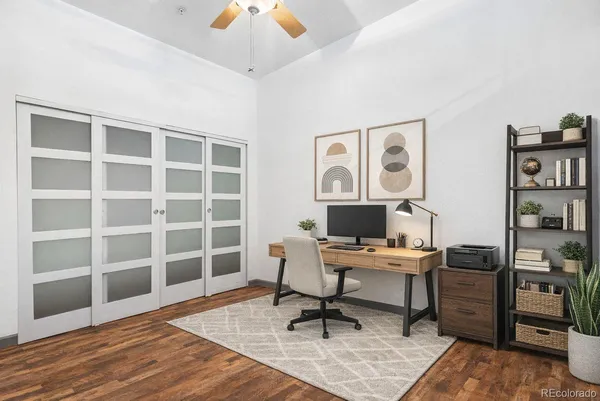 a view of a workspace with furniture and a window