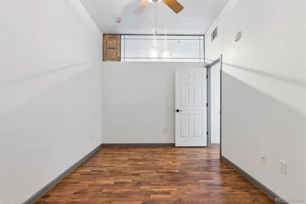 a view of a room with wooden floor