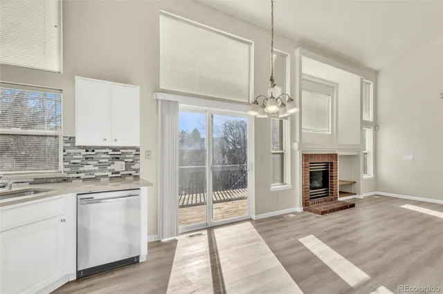 a open kitchen with granite countertop a sink stainless steel appliances and cabinets